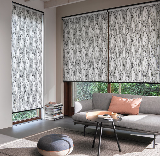 Roller blinds in a lounge setting.  Available in a wide range of patterned fabrics.
